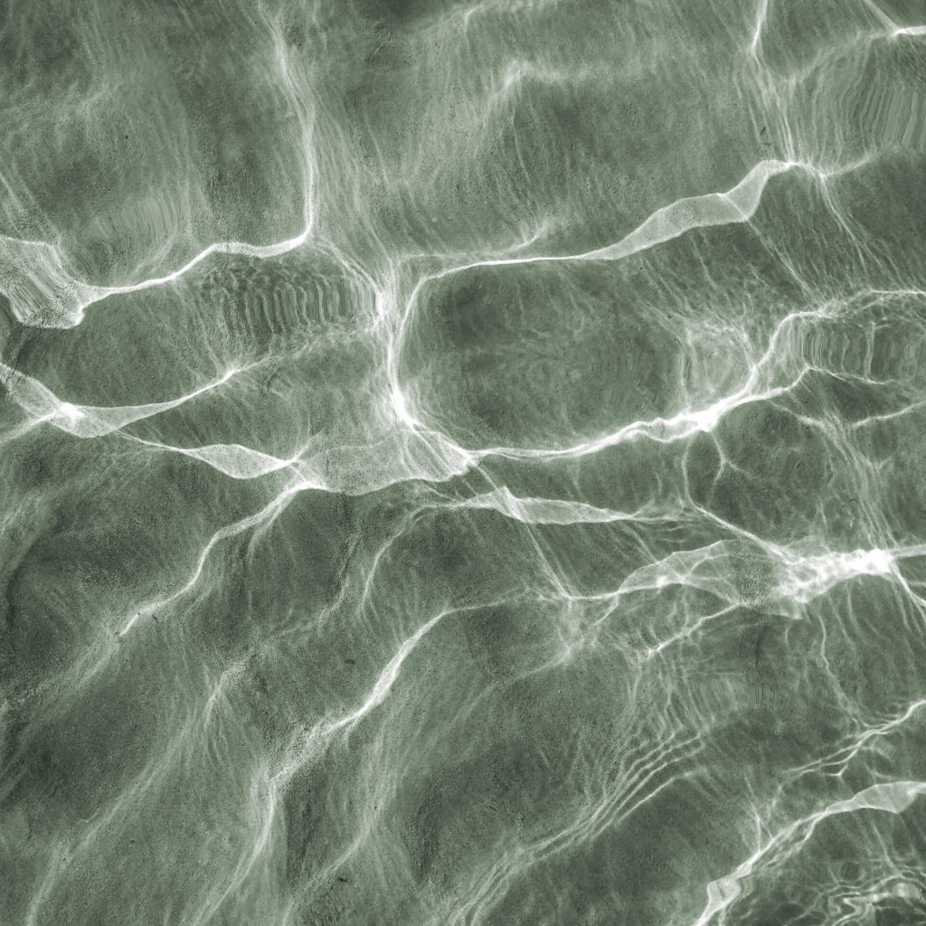 An overhead shot of the water surface under sunlight